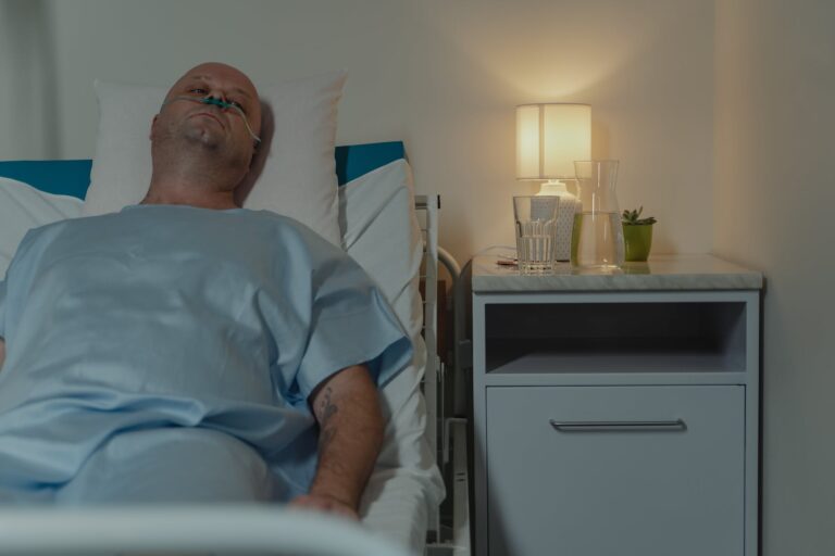 man in blue scrub suit lying on bed